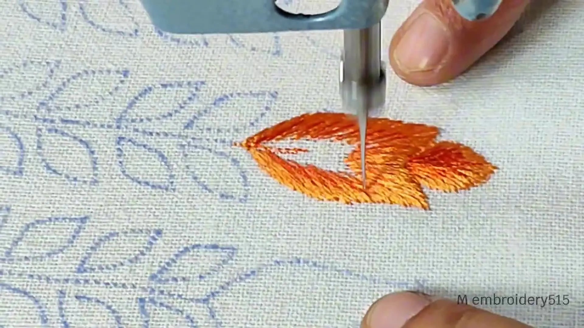 The main leaf is almost entirely filled with orange embroidery, with only a small section remaining to be completed.