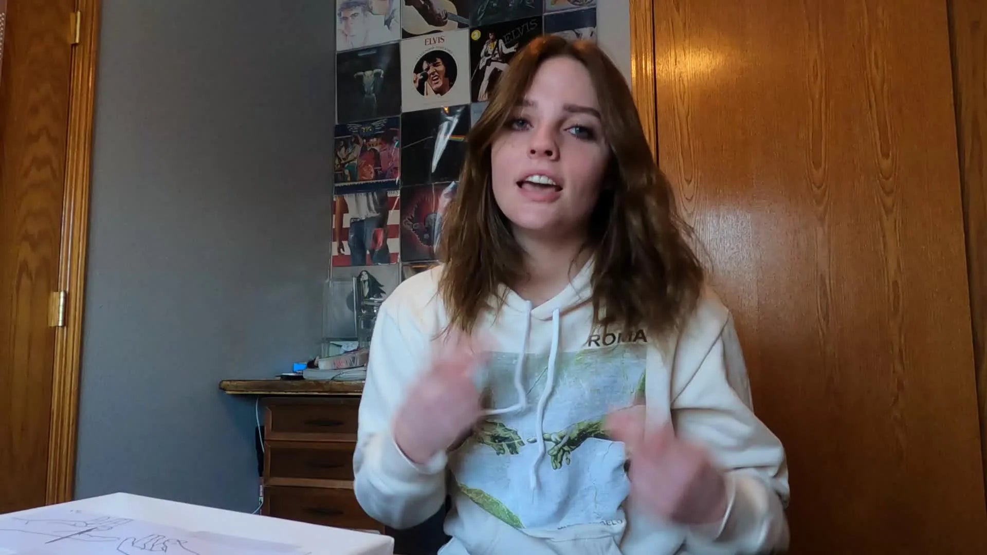 Woman in a hoodie introducing the video topic.