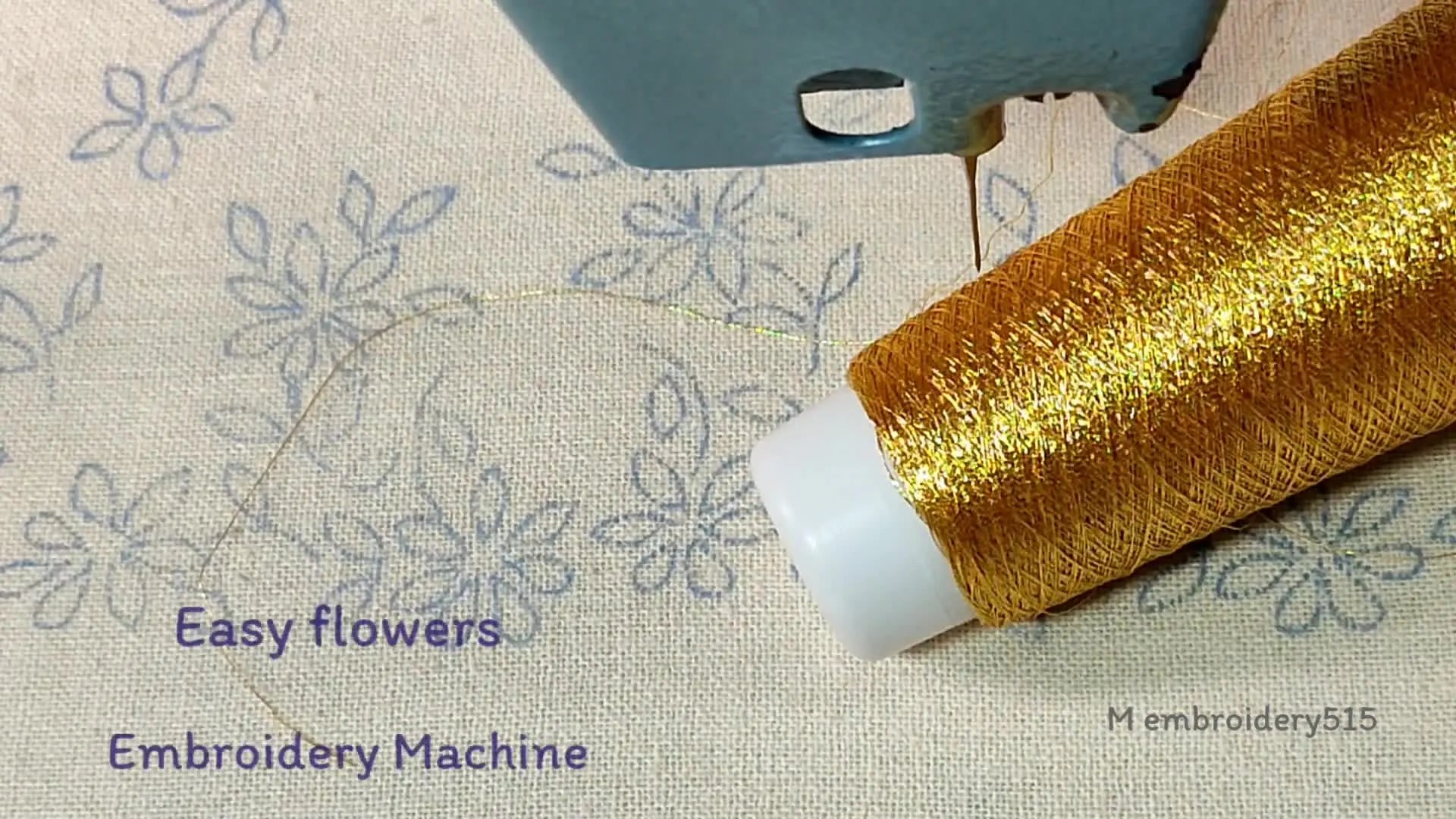 Embroidery machine setup with gold metallic thread and fabric