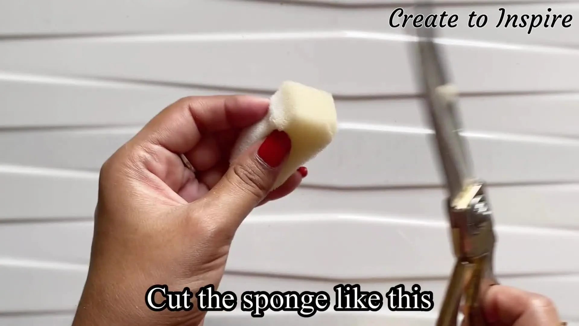 Scissors cutting a sponge into a specific shape.