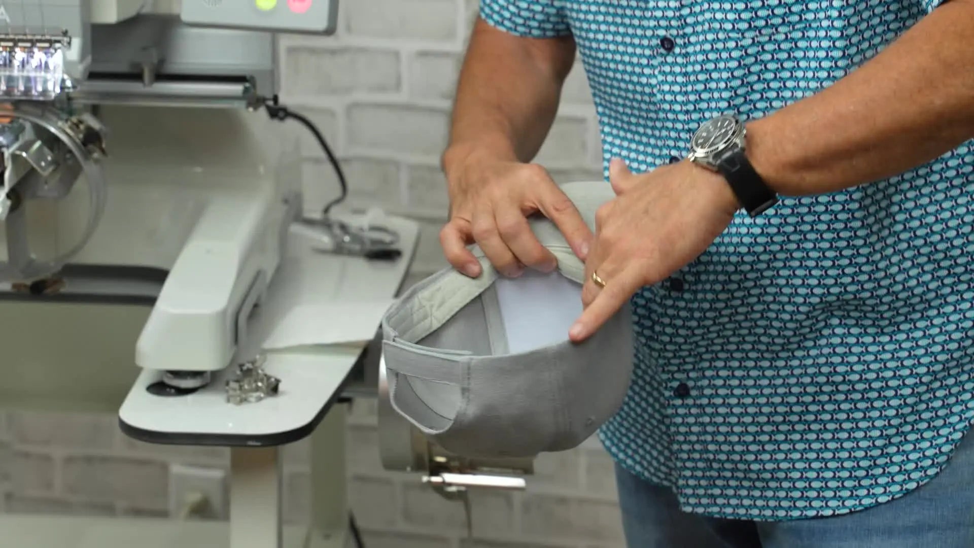Man inserting a white stabilizer piece into a hat.