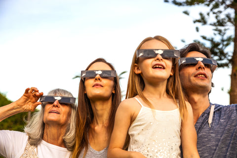 family views a solar eclipse