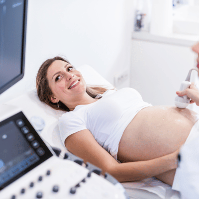 This image show a happy pregnant woman doing ultrasound