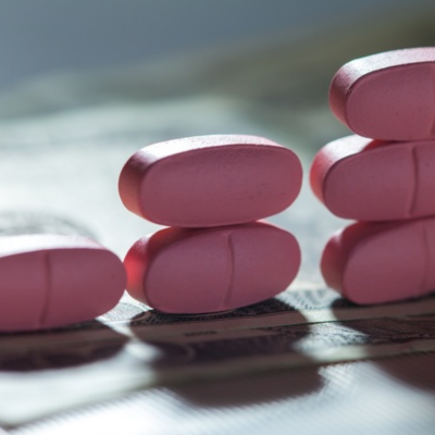 The image shows a group of pink pills.
