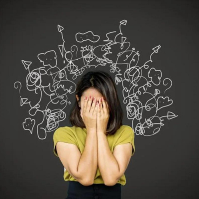 The image shows a woman with her hands on her face standing in front of a blackboard. She appears to be in a state of distress or contemplation. The woman is wearing clothing and is likely a model in an art piece.