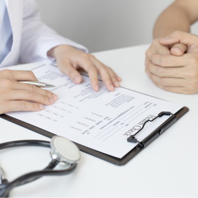 The image shows a piece of paper of the doctor and sitting with a patient indoor.