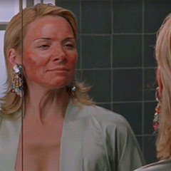 Mujer mirándose al espejo con la piel quemada