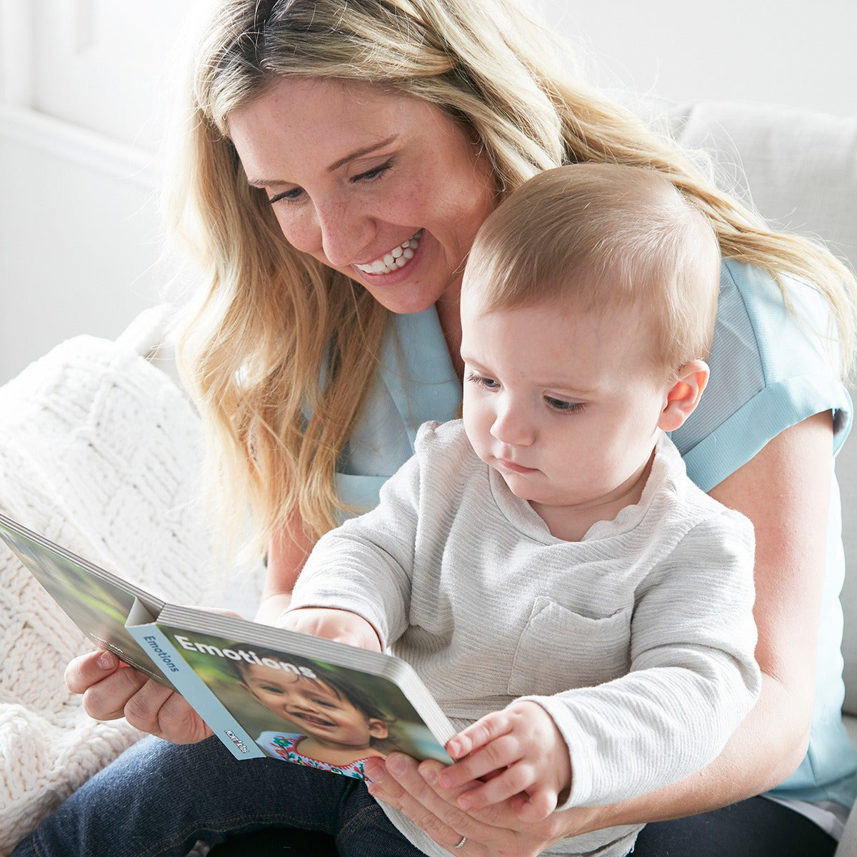 Mother reading the emotions book to her little one