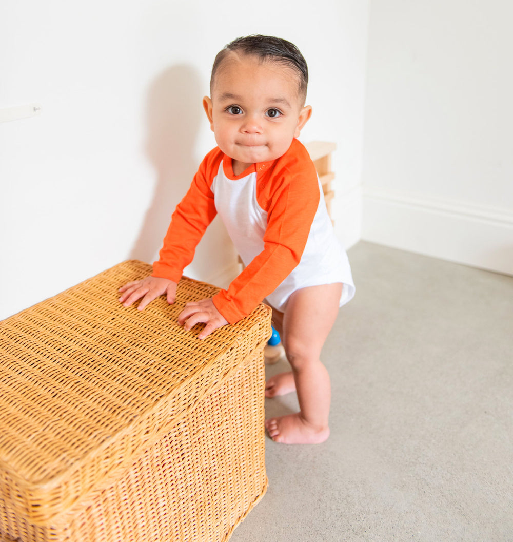 Baby standing holding on to furniture