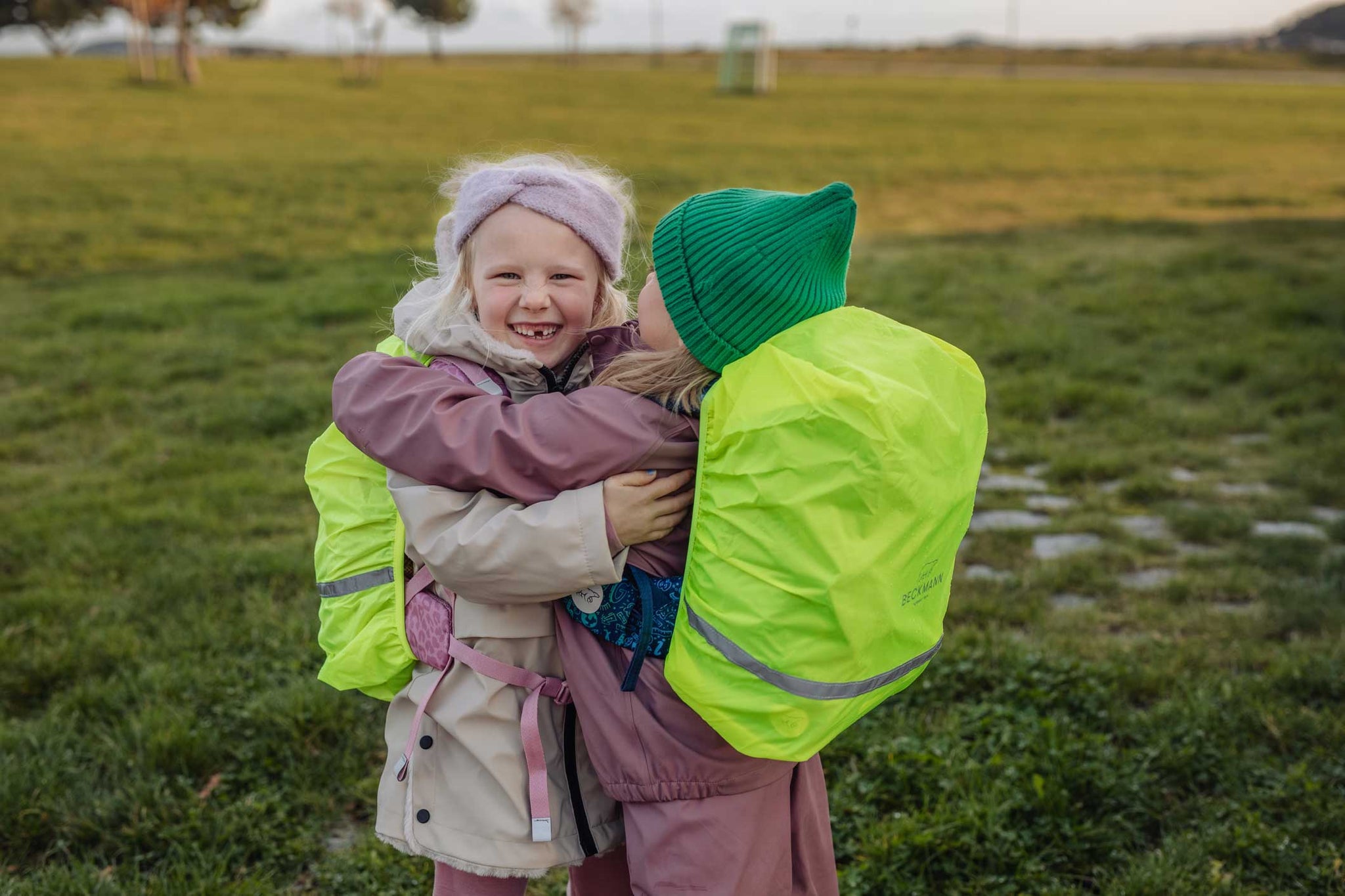 Children with rain cover on their backpacks