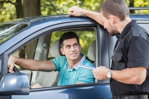 young driver talking experienced policeman