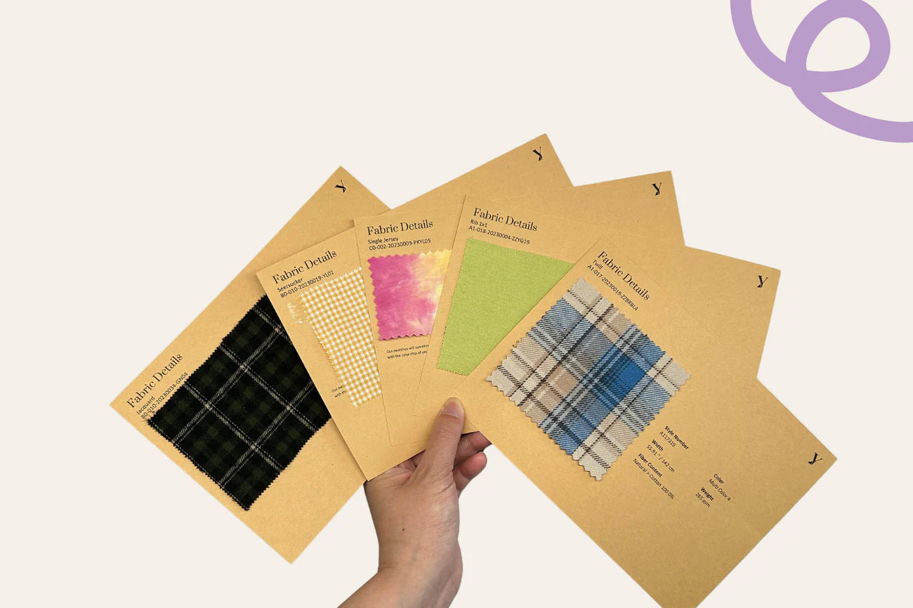 Hand holding 5 cards showing fabric samples