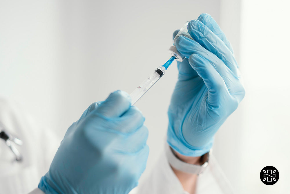 Syringe on hands with blue gloves