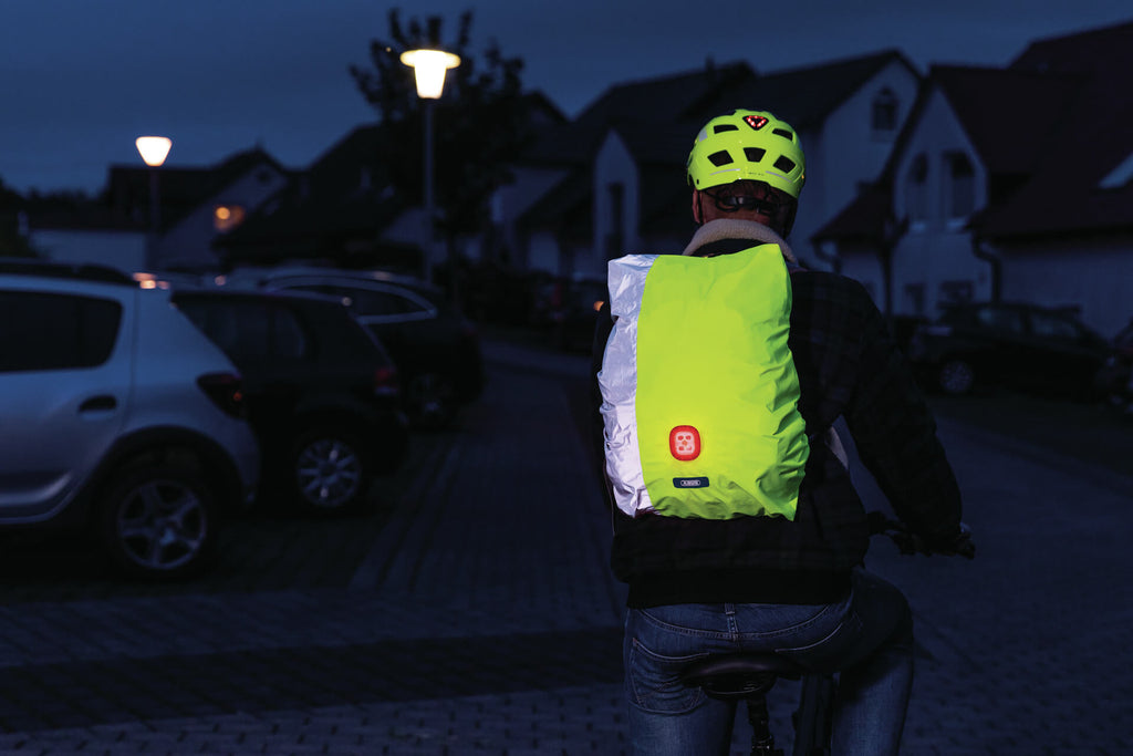 abus luminos night cover on the rider backpack, riding in the dark on a residential road
