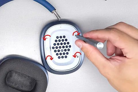 Loosening screws with a screwdriver.