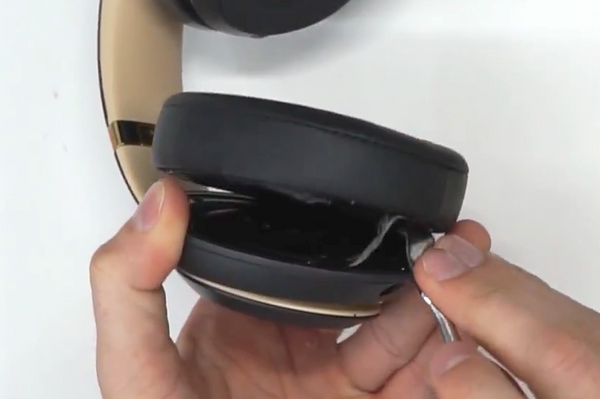 Revealing the tape and residue on the speaker housing