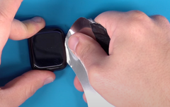 Applying pressure to the thin pry tool to lift the screen on the Apple Watch Series 7