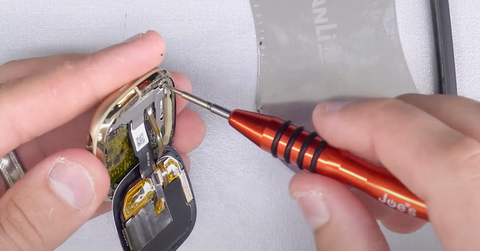 Removing the two T2 screws that hold the Fitbit Sense screen connectors in place