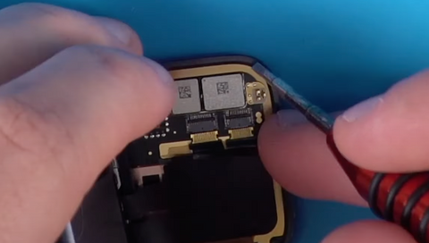 Sliding the two connectors into their latches on the back of the series 7 Apple Watch