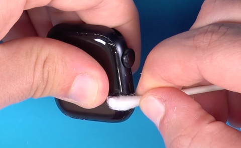 Use a Q tip to remove any excess adhesive from the outside of the Series 7 Apple Watch