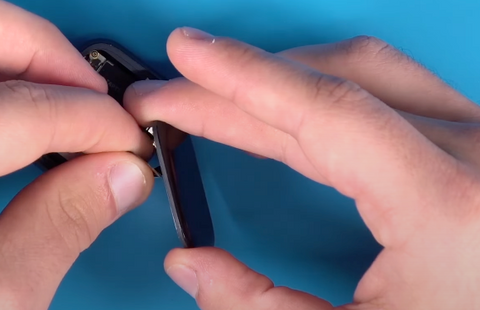 Pulling the ribbons from the back of an Apple Watch Series 7 screen
