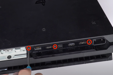 Remove the 3 screws on the back of the Playstation