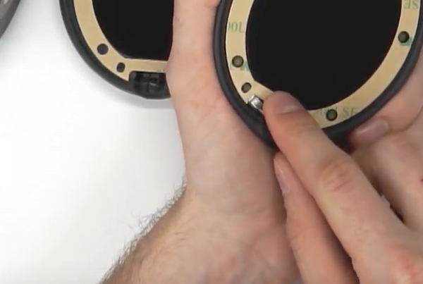 Using a screwdriver to peel the backing off of the tape