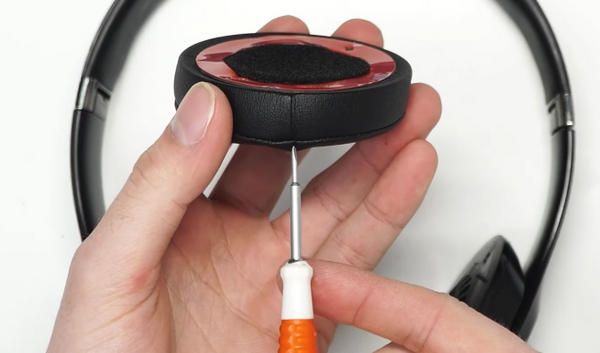 Lining the seam on the earpad up with the bottom of the headphones