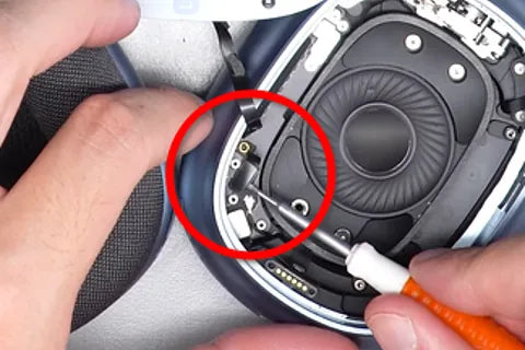 Detaching speaker ribbon with flat screwdriver.