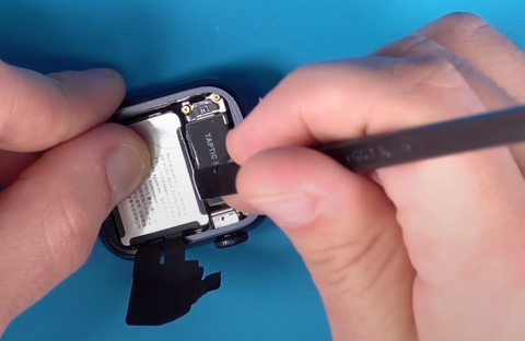 Putting rubbing alcohol down near the battery to release the adhesive on the Apple Watch Series 7