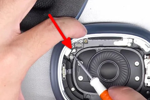 Detaching ground wire with flat screwdriver.