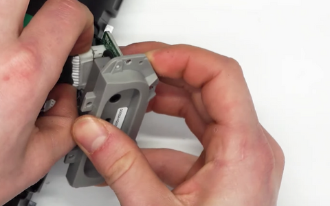 Removing the large plug that is attached to the charge port circuit board. 