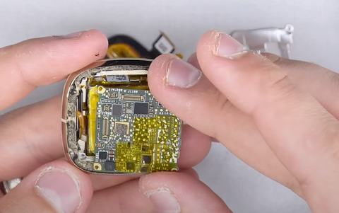 Placing the Fitbit Versa 3 motherboard over the top of the battery