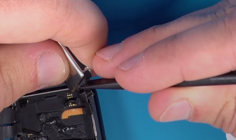 Unclipping the battery connector on the Apple Watch Series 7