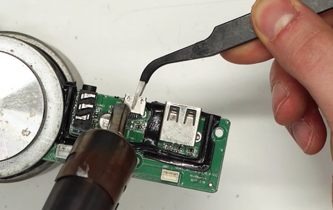Heating up the old charge port with a heat gun 