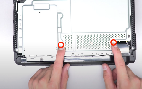 Remove the two screws that secure the bottom part of the power supply