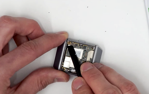 Removing the metal bracket that secures the battery ribbon plug