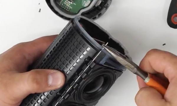 Pulling the loosened pin out of the speaker with pliers