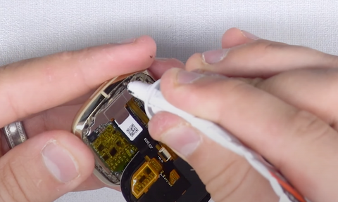 Placing a thin line of glue along the edge of the housing for the Fitbit Sense screen to sit on