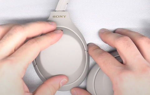Placing the touchpad cover onto the headphones