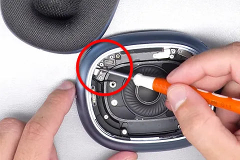 Attaching speaker ribbon to Bluetooth board with flat screwdriver.