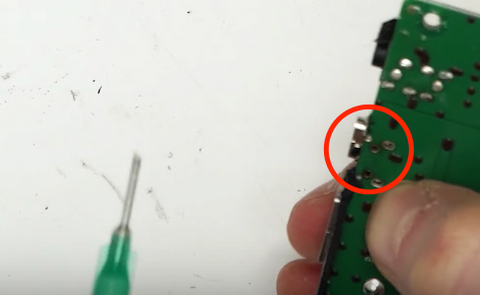 The anchor points on the charge port should slide into the holes in the PCB