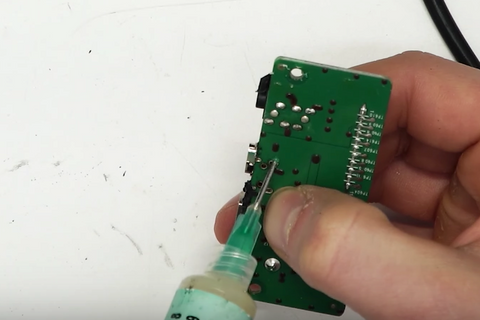 Applying flux to the anchor points and circuit board