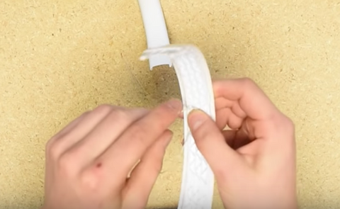 Placing the mid point of the wire into the headband