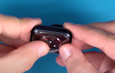 Pressing the new back cover into place on the Series 7 Apple Watch
