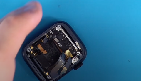 Installing the two screws back into the silver bracket inside of the Apple Watch Series 7