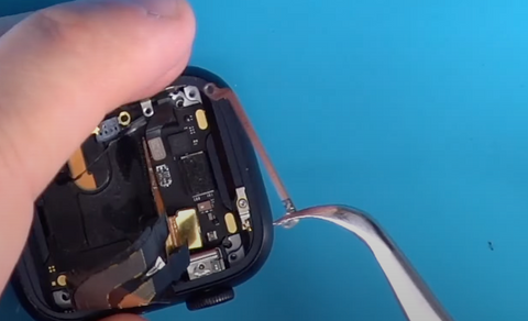 Installing the metal brace back into the inside of the Apple Watch Series 7