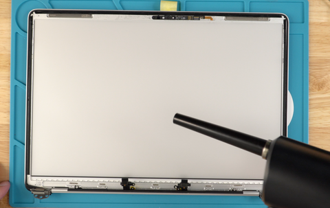 Use your air blaster to remove any remaining particles from the screen diffuser on this 13" MacBook Pro
