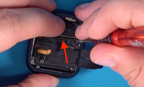 Pressing the black plastic divider back towards the Taptic Engine in the Series 7 Apple Watch back cover replacement