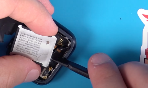 Sliding the battery cable back into it's spot on the side of the battery then locking it in place on the Series 7 Apple Watch